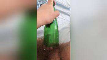 video of Hairy natural Girl putting a 7up bottle in her pussy 