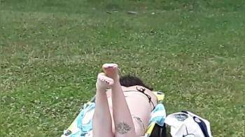 video of carelessly sunbathing in the park