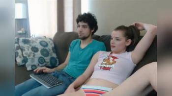 video of Couple plays on the couch for the camera