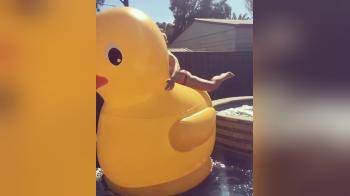 video of Cute girl jumps on big duck with slowmo