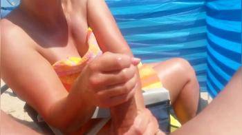 video of Handjob on the beach with big cumshot by hot milf 