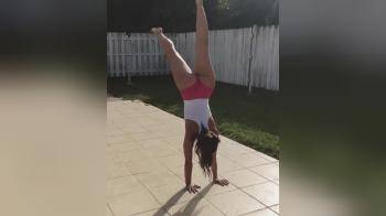 video of Hot brunette doing handstand