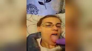 video of nerdy girl sucking her purple dildo