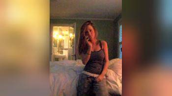 video of College girl striping while on Phone