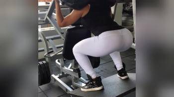 video of Fit girl in white pants squating in the gym