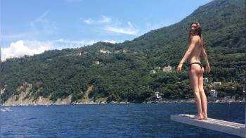 video of Cute topless girl on boat jump into the water