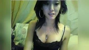 video of Asain babe strips & uses dildo on cam