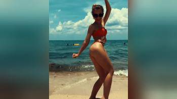 video of Hot skinny girl dancing on the beach