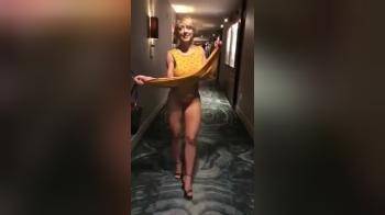 video of Walking thru hotel corridor strips off her dress