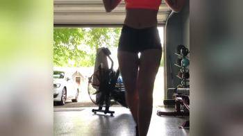 video of Fit girl does squats in the garage.