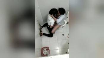 video of Two black girls on public toilet fingering each other