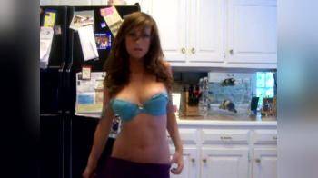 video of Cute girl with big tits stripping in the kitchen
