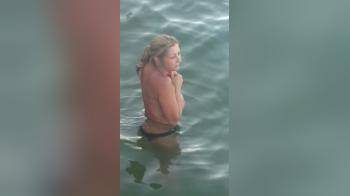 video of Blonde topless in the water