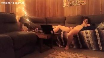 video of Cute horny girl watching laptop porn and masturbating on the couch
