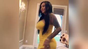 video of Latina with curves strips naked and plays on bed