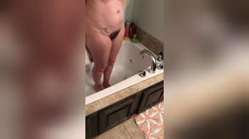 video of Wife standing in bath tub with towel