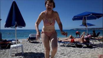 video of older wife on the beach in her bikini