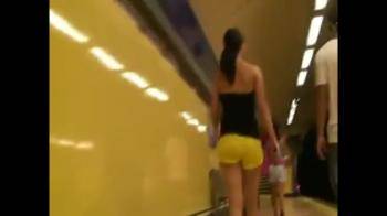 video of following girl in yellow hot pants