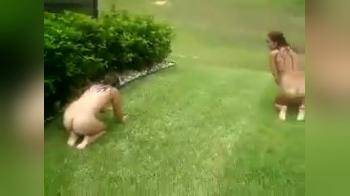 video of Two Girls Streaking Across Lawn