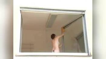 video of Gorgeous redhead cleaning window