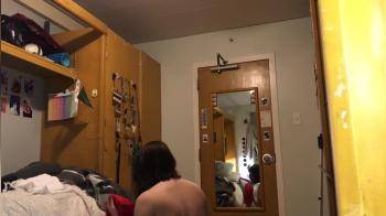 video of college girl trying on outfits in dormroom