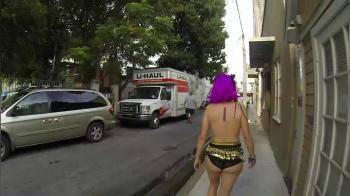 video of masked purple hair topless walk on public street