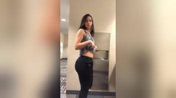 video of sexy brunette teasing in public bathroom