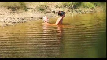 video of Lucky old man seems to have a hot looking younger girl to play with in the lake