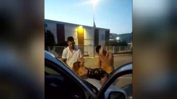 video of friends having some kind of a threesome against the car in public