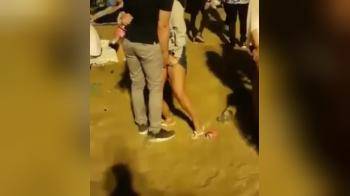 video of Guy fingers a chick during an outdoor festival, she can hardly stand on her legs