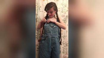 video of Girl in and out of coveralls
