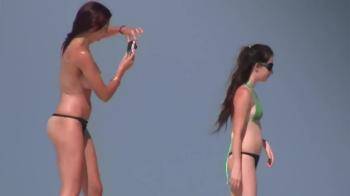 video of Hot topless girls on the beach taking pictures
