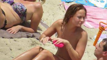 video of Hottie topless on the beach with her boyfriend