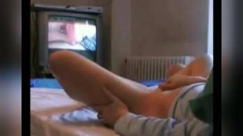 video of Masturbating as she watches porn