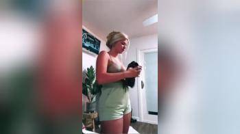 video of Girl Trying on a shirt caught in a mirror