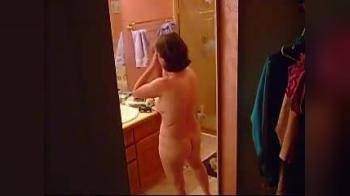 video of Average thick MILF strips, stretches in bathroom