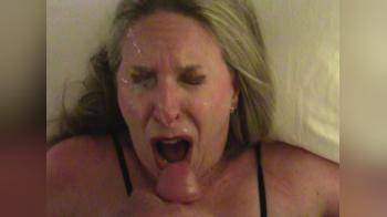 video of Cum loving mature blonde takes a blast of cum to her face and then licks and sucks his cock clean