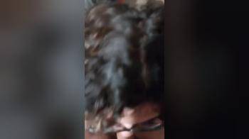 video of latina in glasses blowing