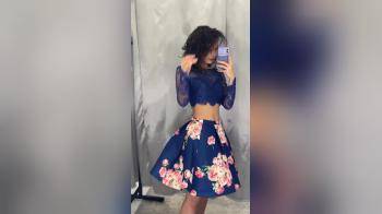 video of girl in a blue dress in front of a mirror