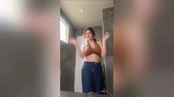 video of Redhead beauty removing her clothes