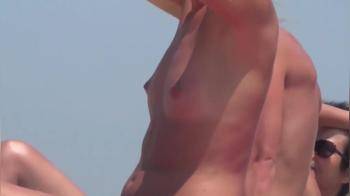 video of Girl with lovely bare titties at the beach