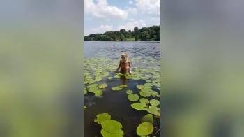 video of blond girl coming out og the water