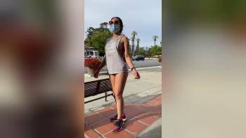 video of girl with mask falshes in the street