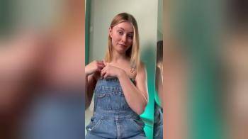 video of Cute blonde has a surprise under her overalls