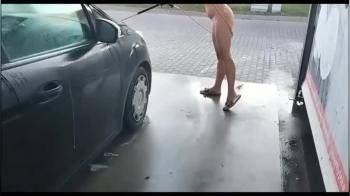 video of In Public, Naked, in the Middle of the City, he Washes his Car at a Car Wash