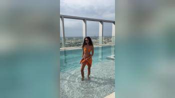 video of orange bikini in pool