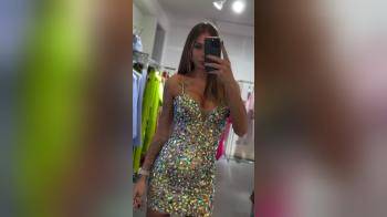 video of trying on shiny dress