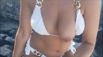 video of Topless on a Public Beach, Massaging her Tits in Front of People