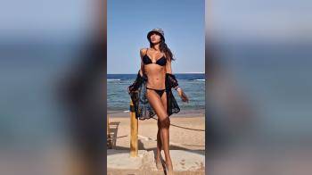 video of black bikini at beach