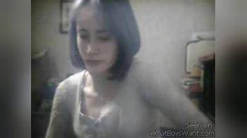 video of brunette playing on a webcam